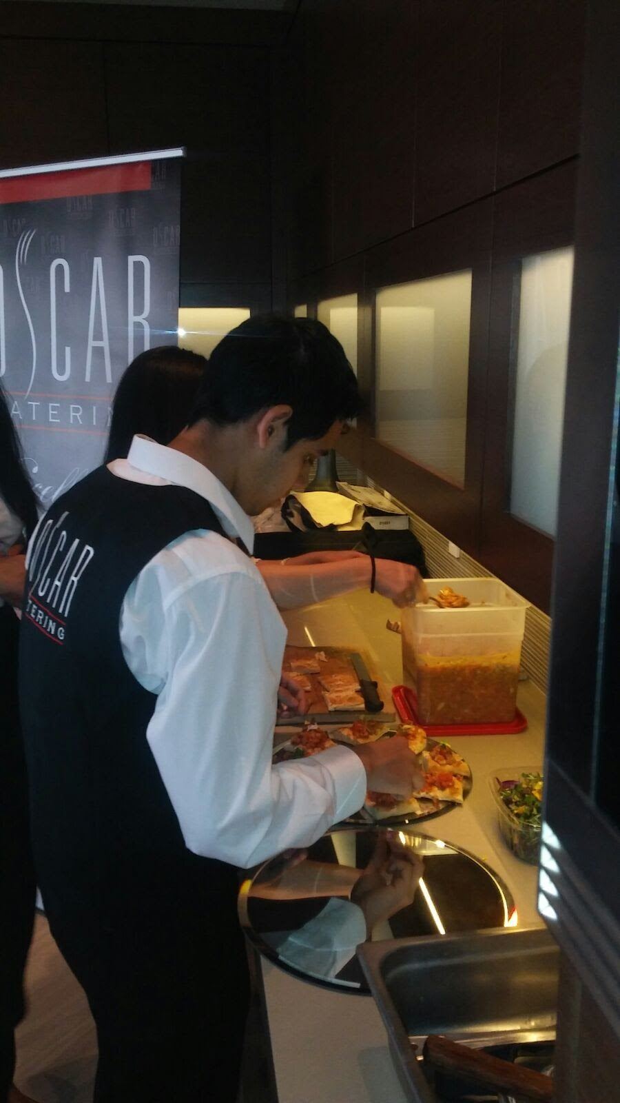 Oscar Catering team member plating canap&eacute;s during service