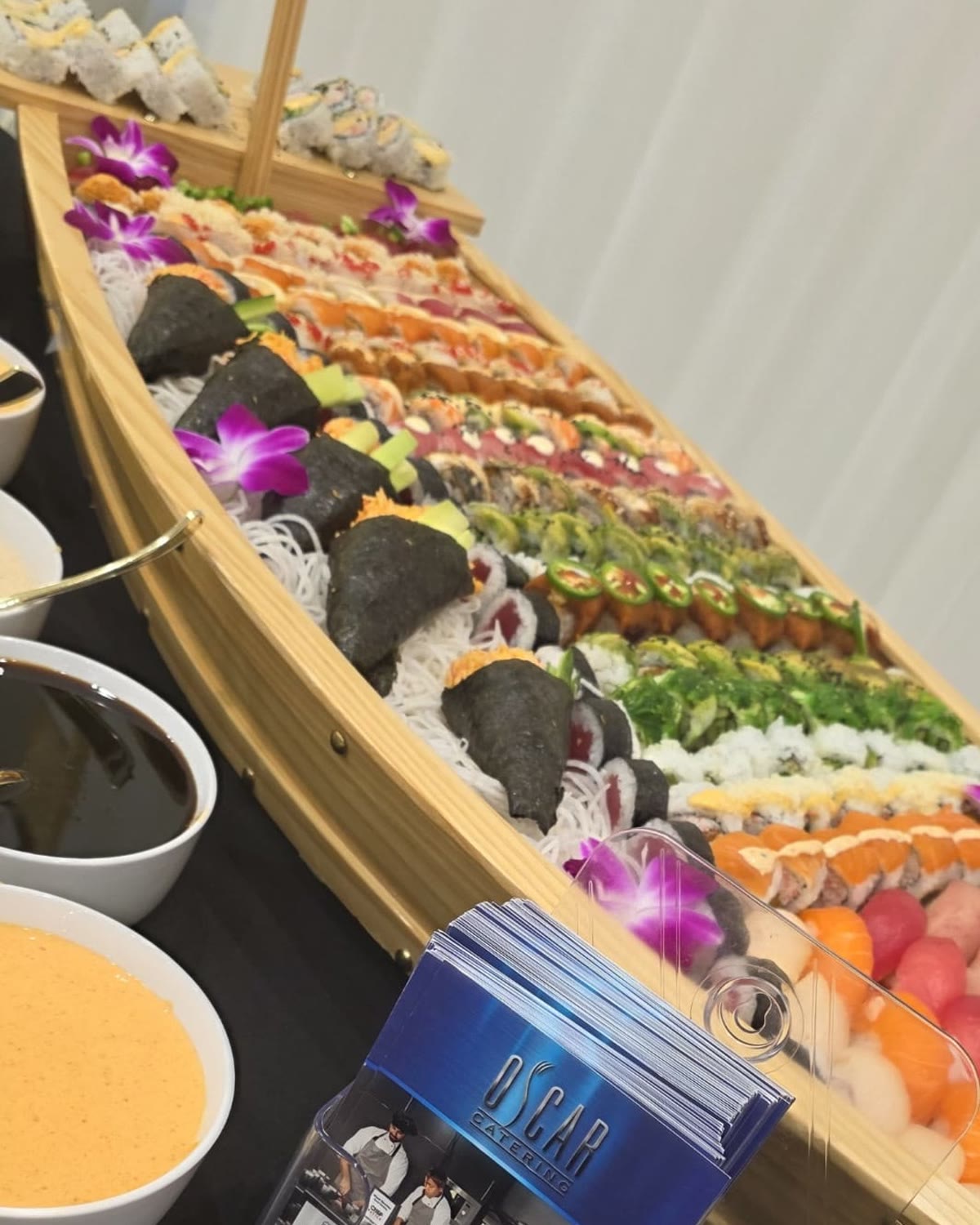 Close-up of hand rolls, specialty rolls and nigiri arranged in a sushi boat
