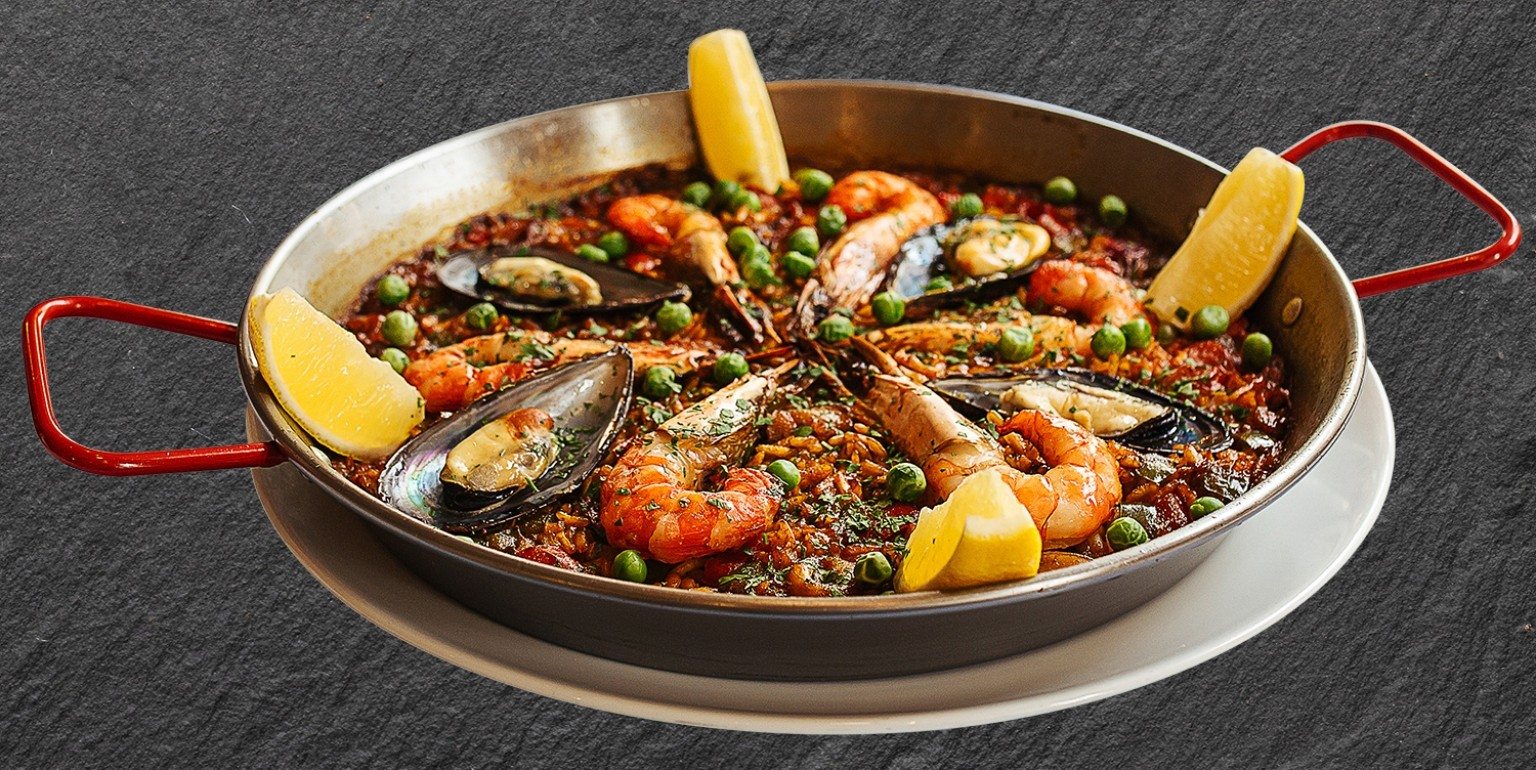 Seafood paella finished in the pan by Chef Oscar Sanchez